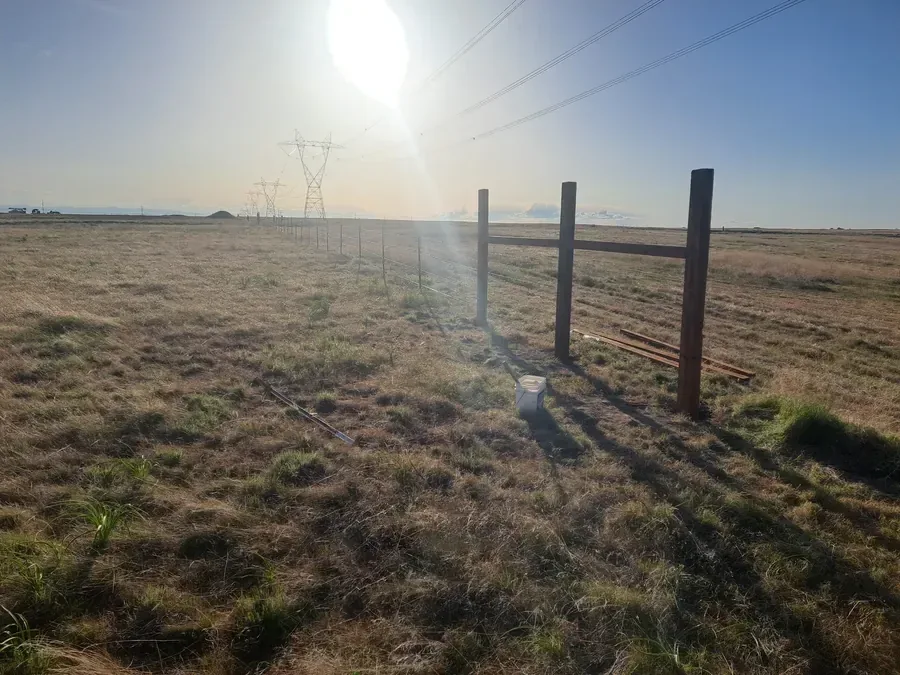 Barbed wire pasture fence on Idaho farm ground