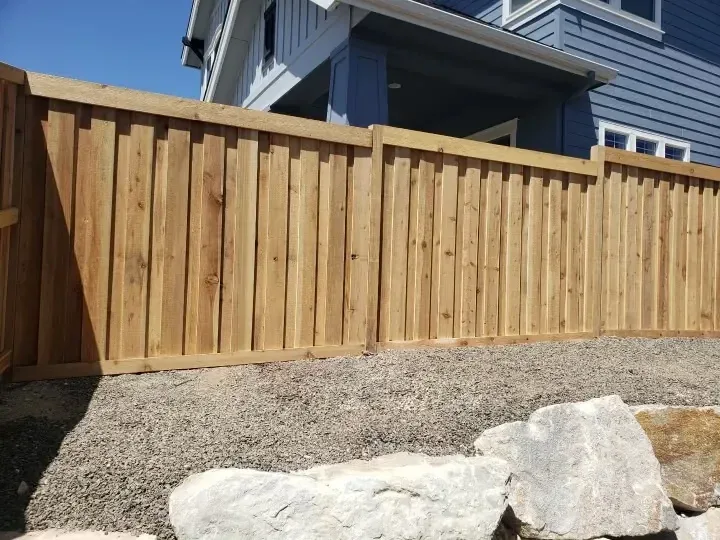 Board on board cedar fence set behind landscape boulders in Boise, Idaho