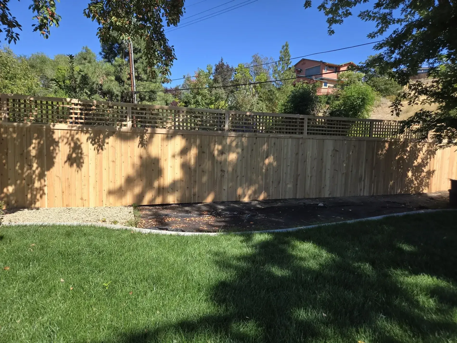 Cedar privacy fence with a lattice top enclosing a Boise backyard lawn