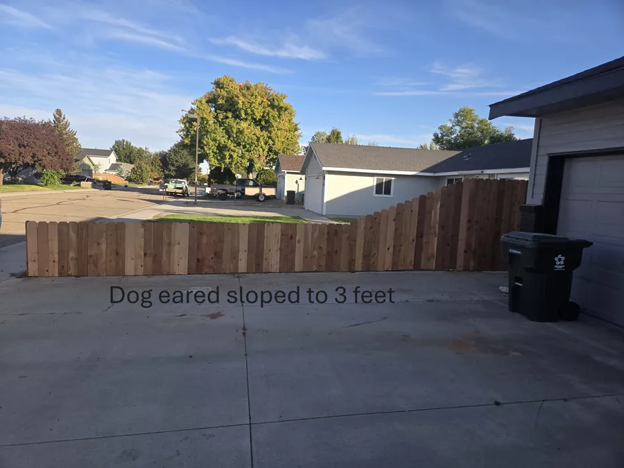 Dog eared cedar fence stepped down to three feet along a Meridian, Idaho driveway
