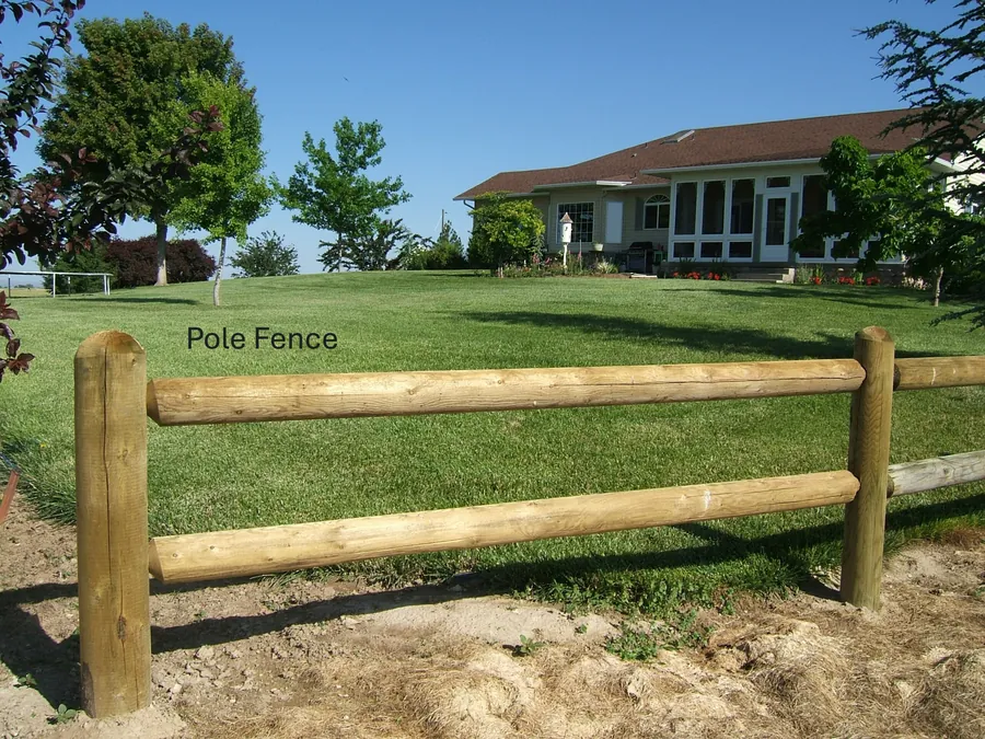 Peeled pole fence framing the lawn of an Idaho ranch home