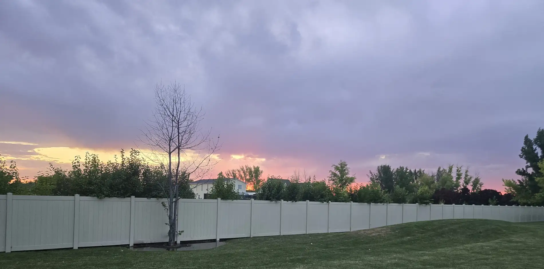 Tan vinyl privacy fence at sunset in Kuna, Idaho