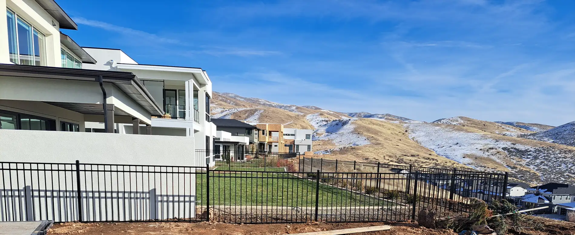 Western three rail wrought iron fence at a new construction home below the Boise foothills