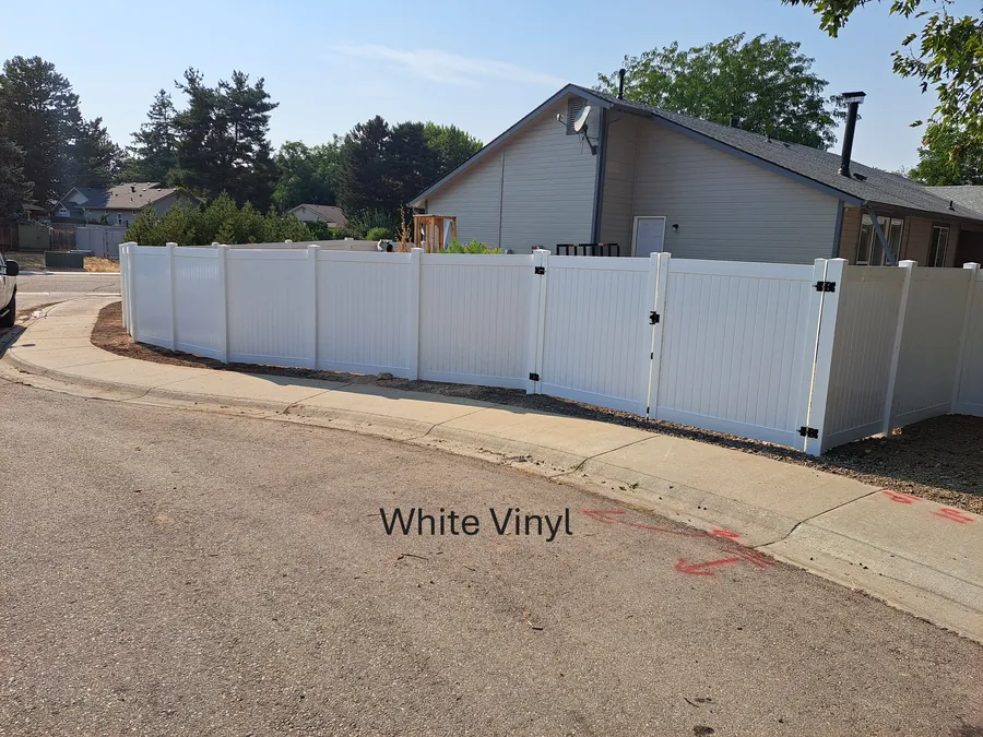 White vinyl privacy fence and double gates along a Meridian, Idaho street