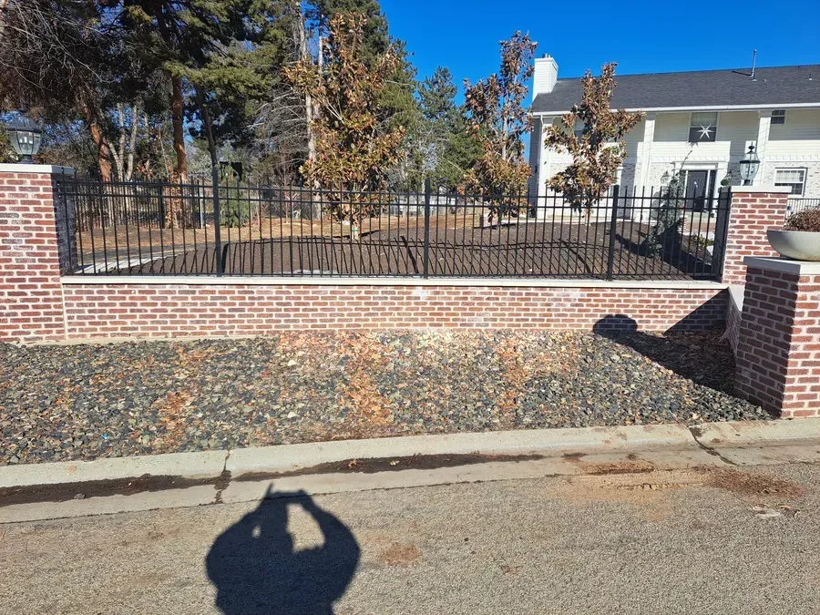 Wrought iron fence mounted on a brick and stucco wall in Boise